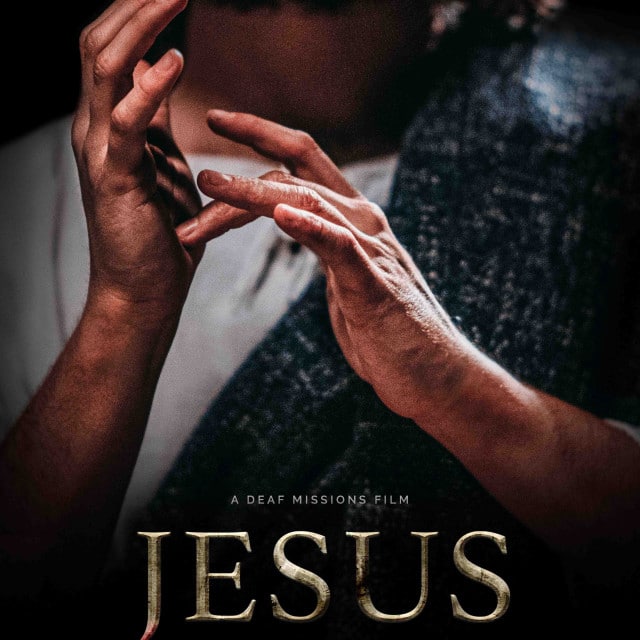 Film Jesus ASL Środkowy palec jednej dłoni mężczyzny dotyka drugiej dłoni. U dołu napis Jesus